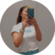 Mirror selfie of a woman in a white t-shirt